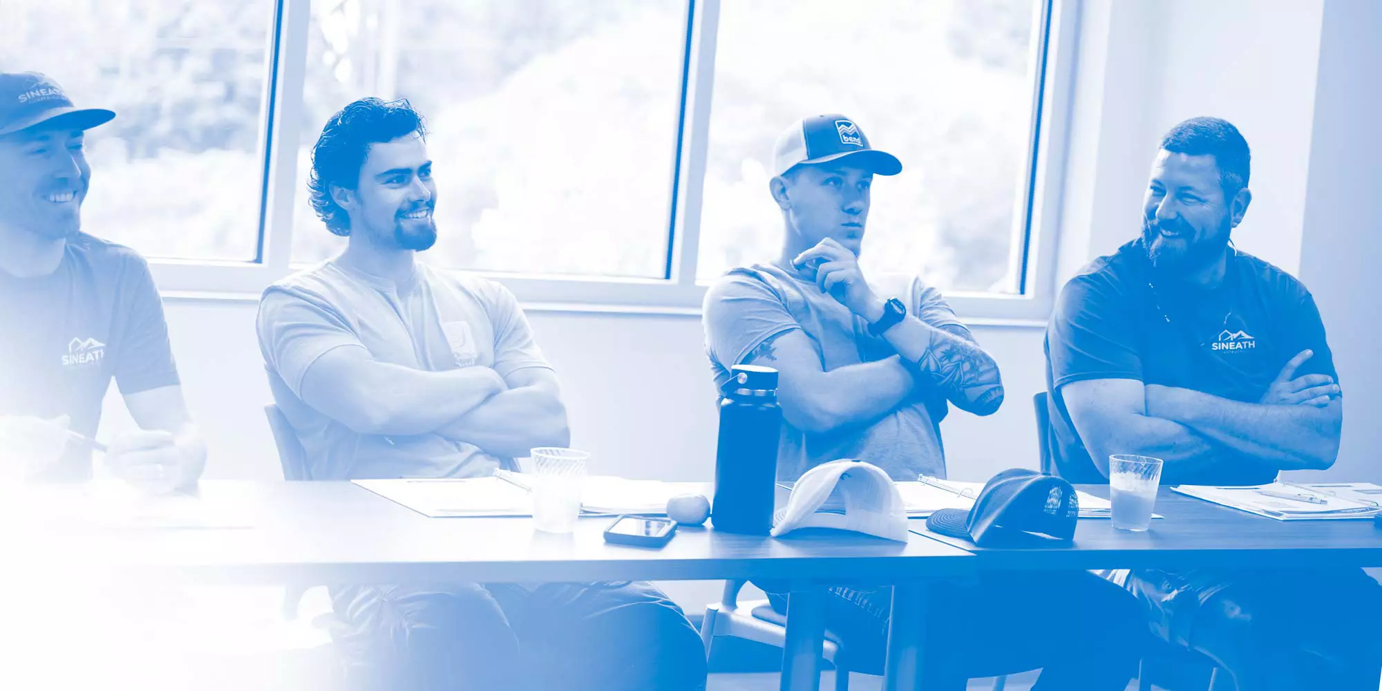 four men sitting at table during certifications course