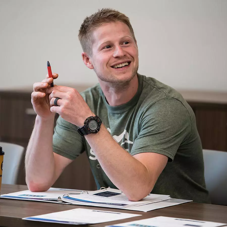 male general contractor sitting at table during course